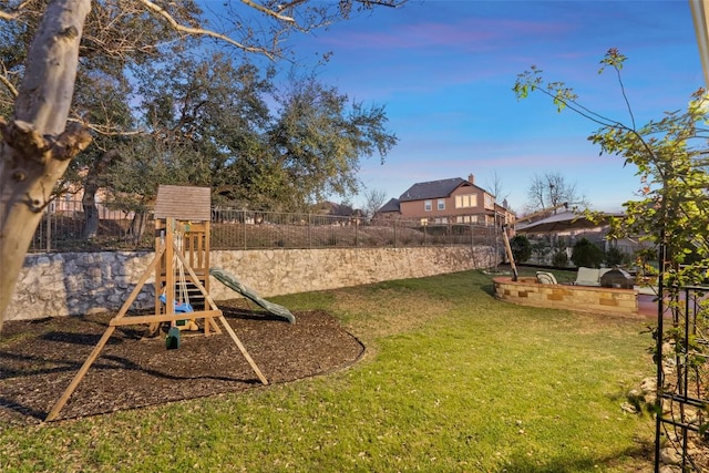 view of yard with a playground and a fenced backyard