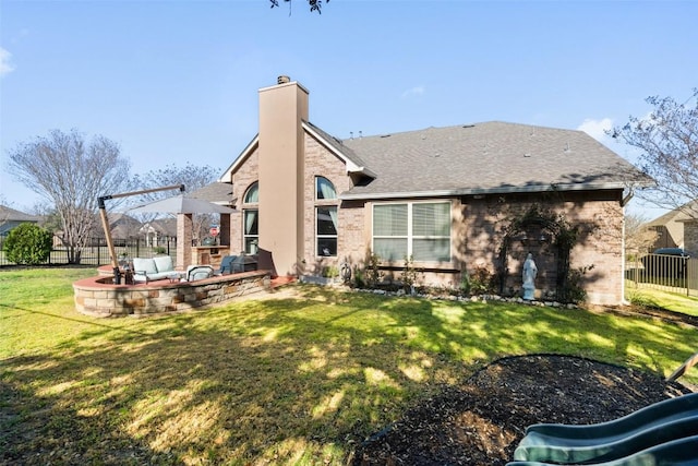 back of house featuring fence, roof with shingles, a chimney, a yard, and a patio area