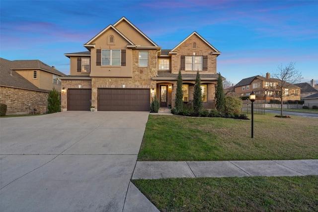 view of front facade with stucco siding, an attached garage, concrete driveway, and a front yard