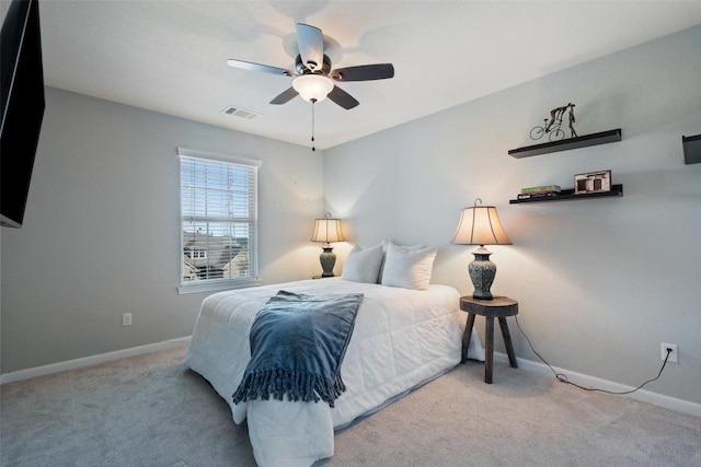 carpeted bedroom featuring visible vents, baseboards, and ceiling fan