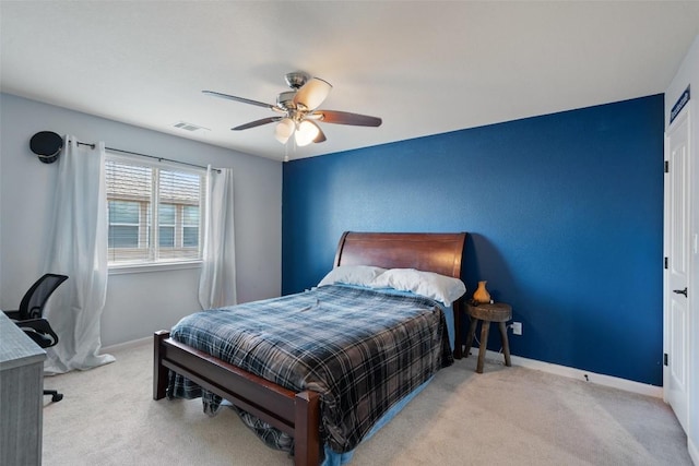 carpeted bedroom with baseboards, visible vents, and ceiling fan