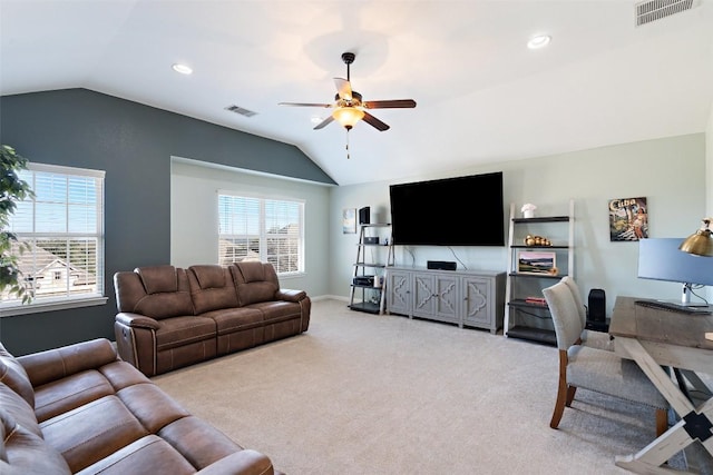 living room with visible vents, lofted ceiling, and light carpet