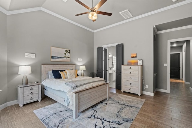 bedroom featuring visible vents, ornamental molding, a ceiling fan, wood finished floors, and baseboards