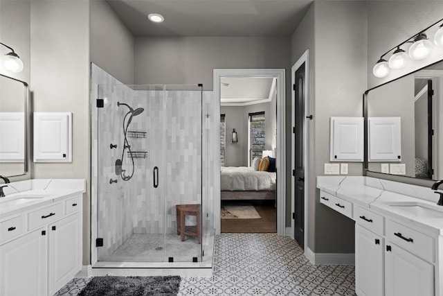 ensuite bathroom featuring a shower stall, two vanities, ensuite bathroom, and a sink