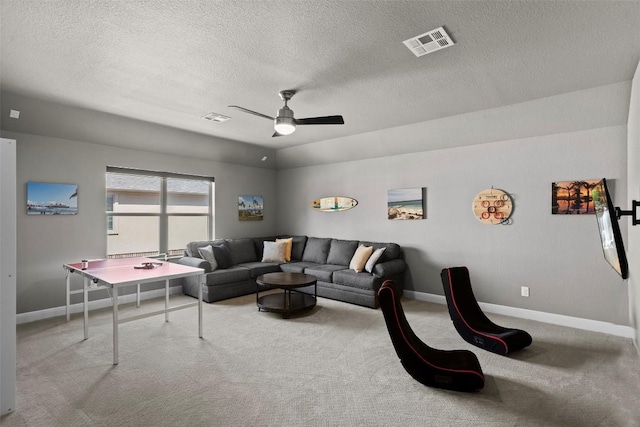 carpeted living room featuring visible vents, baseboards, and a ceiling fan