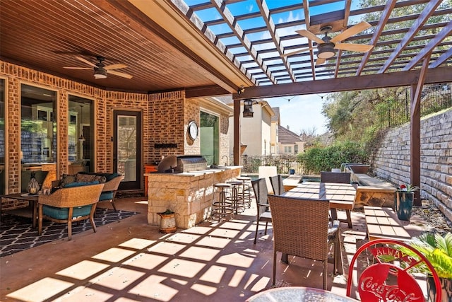 view of patio with outdoor dining space, a ceiling fan, area for grilling, a pergola, and outdoor dry bar