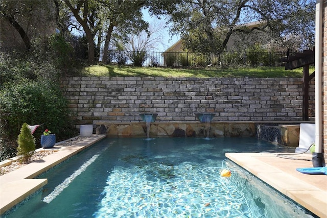 view of pool with a fenced in pool and fence