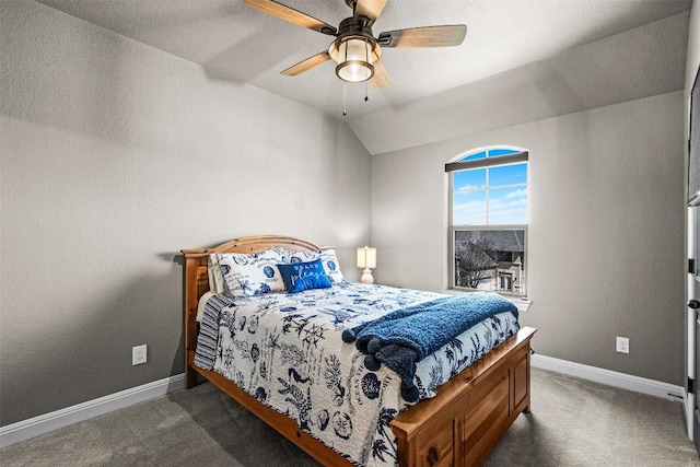 carpeted bedroom featuring a ceiling fan, lofted ceiling, and baseboards