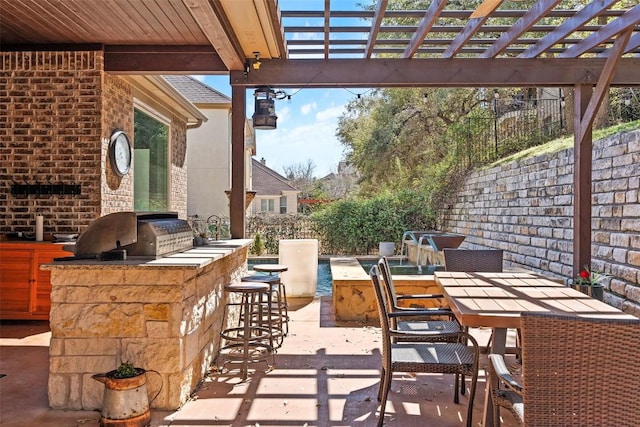 view of patio with area for grilling, outdoor dining space, a pergola, and outdoor wet bar