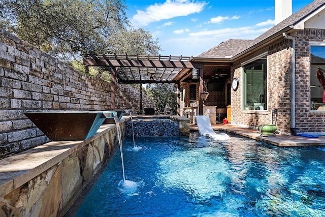 view of pool with a pool with connected hot tub and a pergola