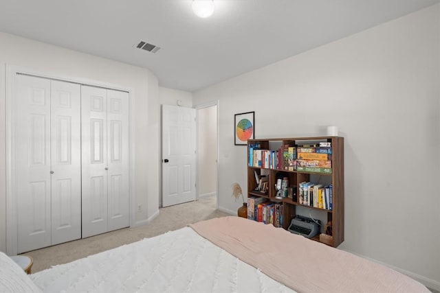 bedroom featuring carpet flooring, baseboards, visible vents, and a closet