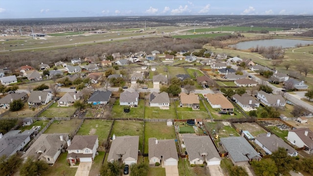 drone / aerial view with a residential view and a water view