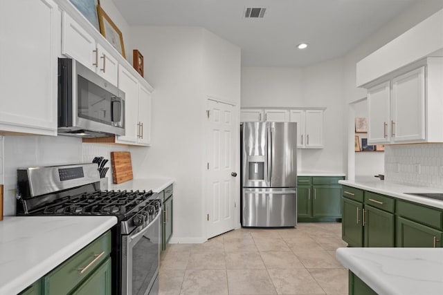 kitchen featuring white cabinets, green cabinetry, stainless steel appliances, and visible vents