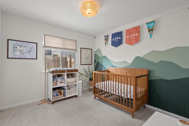 carpeted bedroom with a nursery area and baseboards