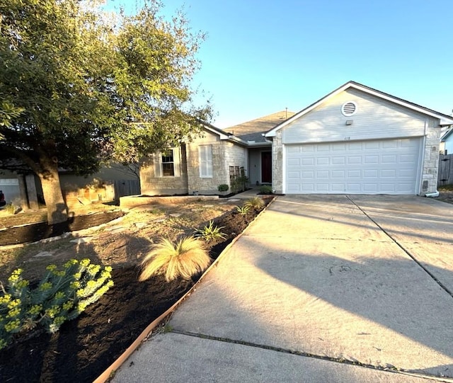 single story home with an attached garage, stone siding, and driveway