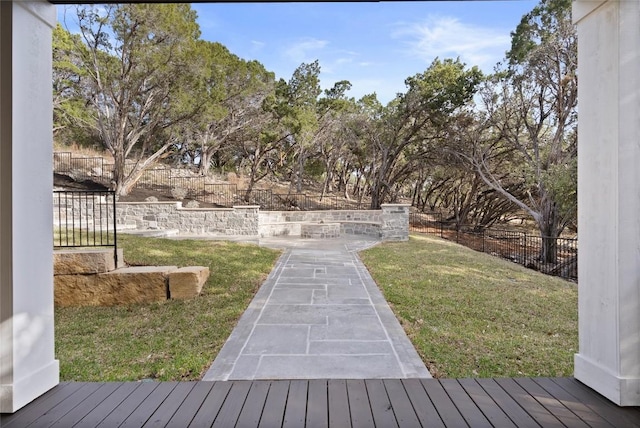 deck with a lawn and fence