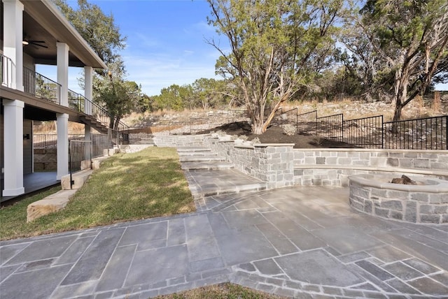 view of yard with a ceiling fan, a patio, an outdoor fire pit, fence, and stairway