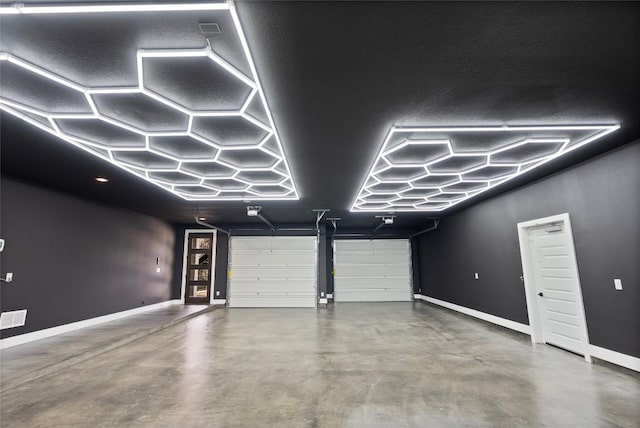 garage featuring visible vents and baseboards