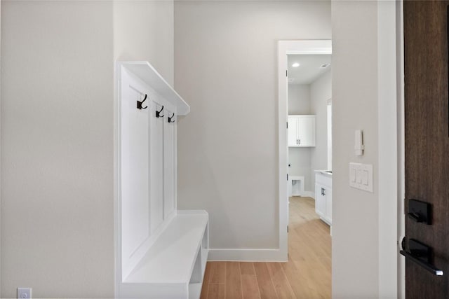 mudroom featuring light wood-type flooring and baseboards