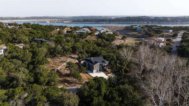 bird's eye view with a forest view and a water view