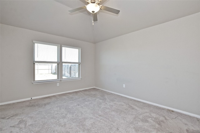 empty room with lofted ceiling, baseboards, carpet floors, and ceiling fan