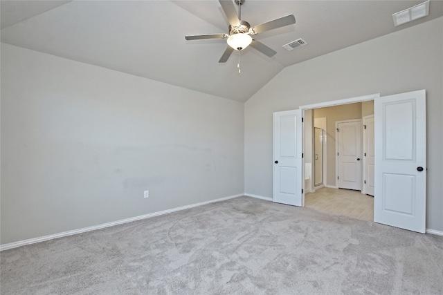 unfurnished bedroom featuring visible vents, baseboards, lofted ceiling, and carpet floors