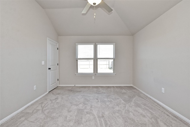 unfurnished room with a ceiling fan, lofted ceiling, carpet, and baseboards