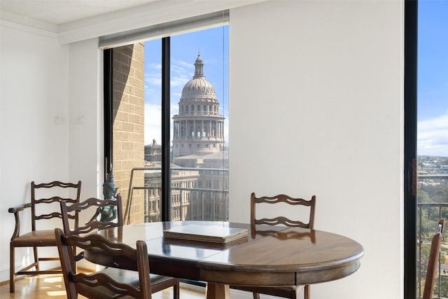 dining area with a wealth of natural light, expansive windows, and a city view