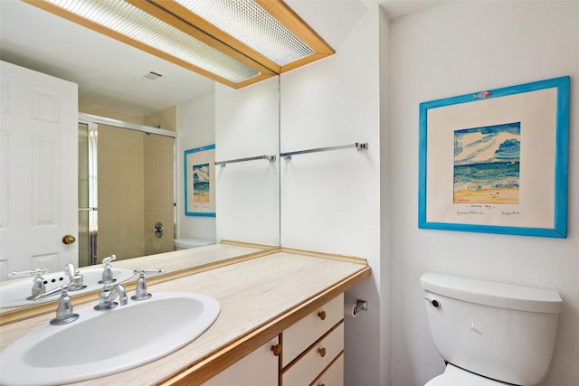 full bathroom featuring vanity, a shower stall, toilet, and visible vents