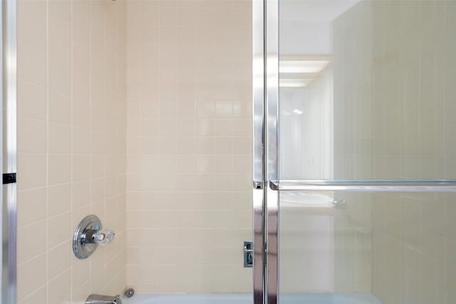 full bathroom featuring combined bath / shower with glass door