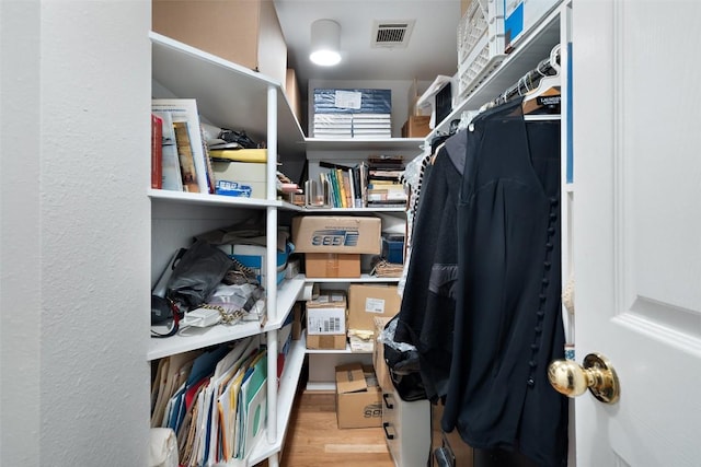 walk in closet with visible vents and wood finished floors