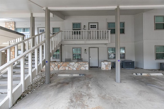 back of property featuring stairs and central air condition unit