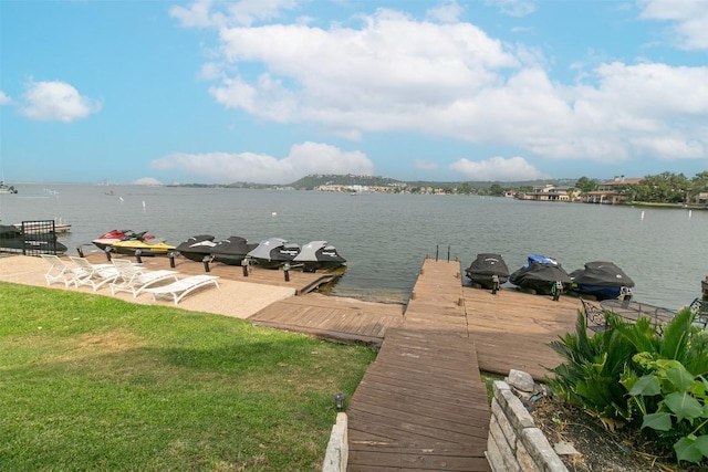 dock area with a water view and a lawn