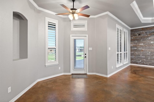 entrance foyer with crown molding, baseboards, concrete flooring, and a ceiling fan