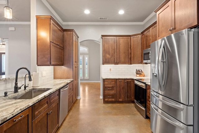 kitchen with visible vents, light stone countertops, appliances with stainless steel finishes, arched walkways, and a sink