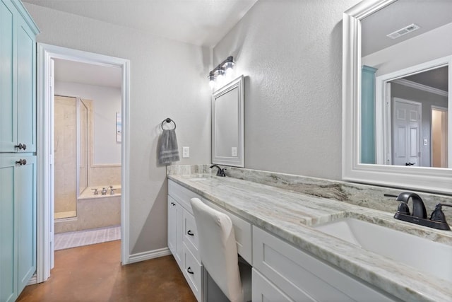 bathroom with double vanity, finished concrete flooring, a bathtub, and a sink