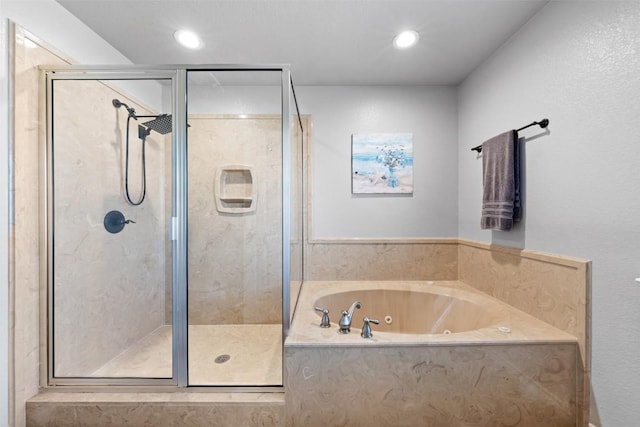 full bathroom with recessed lighting, a stall shower, and a whirlpool tub