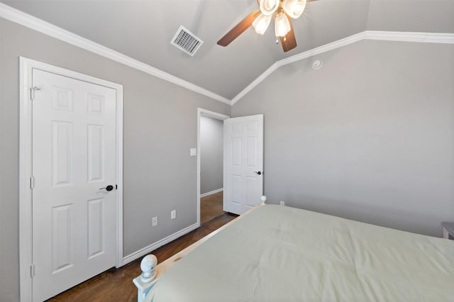 bedroom featuring visible vents, baseboards, lofted ceiling, ornamental molding, and dark wood-style flooring