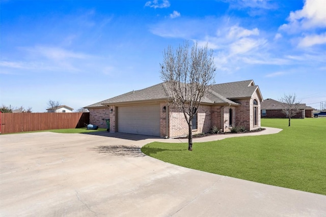 ranch-style home with brick siding, an attached garage, a front lawn, and fence