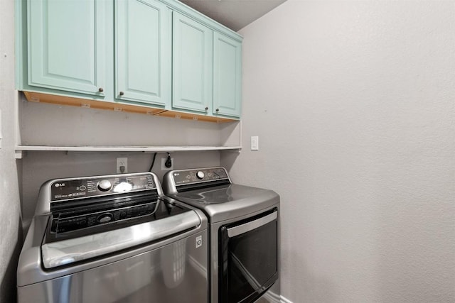 washroom featuring cabinet space and separate washer and dryer