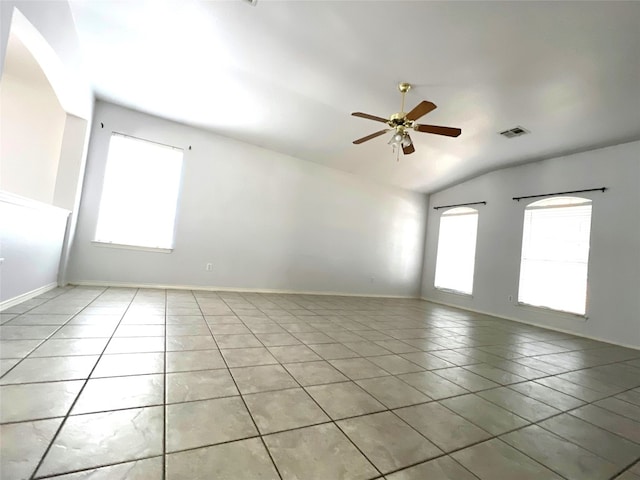 unfurnished room featuring visible vents, light tile patterned flooring, baseboards, ceiling fan, and vaulted ceiling