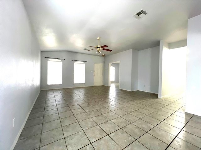 unfurnished living room with light tile patterned flooring, visible vents, baseboards, and a ceiling fan