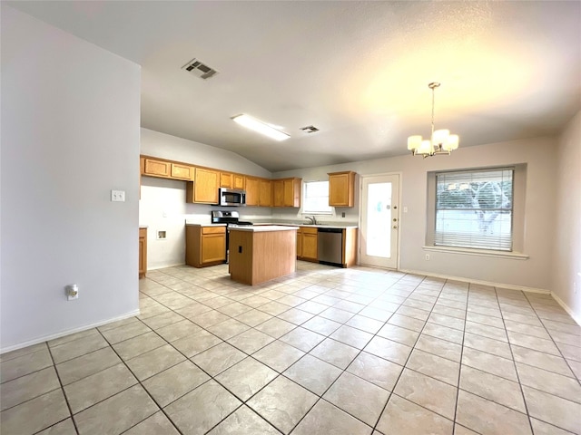 kitchen featuring visible vents, a kitchen island, light countertops, a notable chandelier, and stainless steel appliances