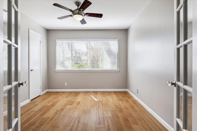 unfurnished bedroom with french doors, baseboards, wood finished floors, and a ceiling fan