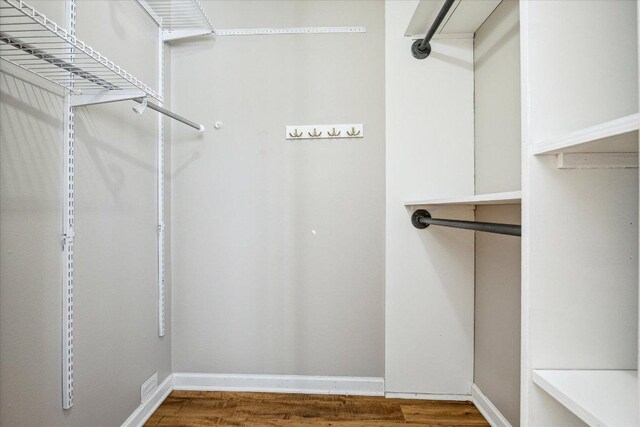 walk in closet featuring wood finished floors