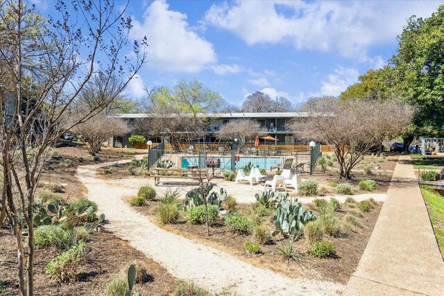 view of home's community featuring fence