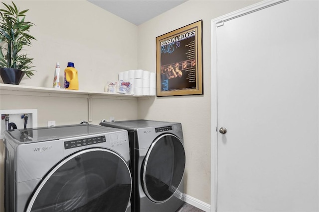 laundry area featuring washer and dryer, baseboards, and laundry area