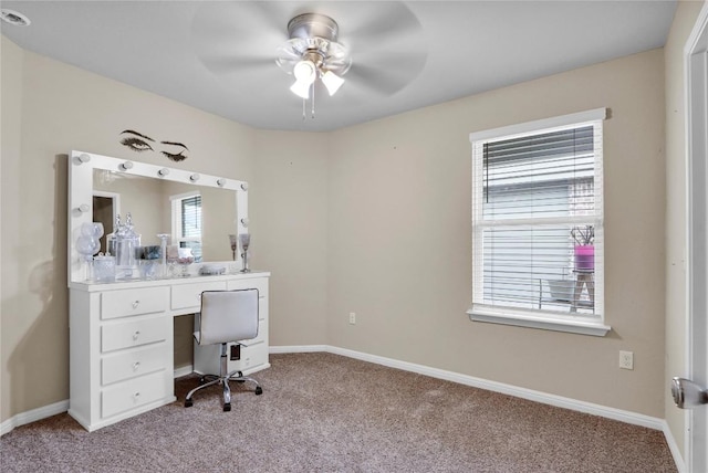 office space featuring ceiling fan, baseboards, and light carpet