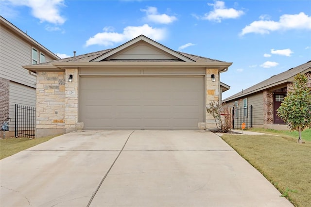 ranch-style house with fence, driveway, a front lawn, a garage, and stone siding