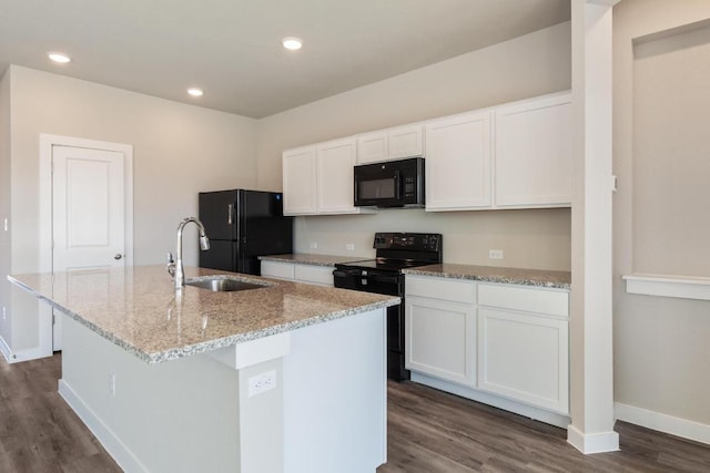 kitchen with black appliances, a kitchen island with sink, a sink, dark wood-style floors, and white cabinetry